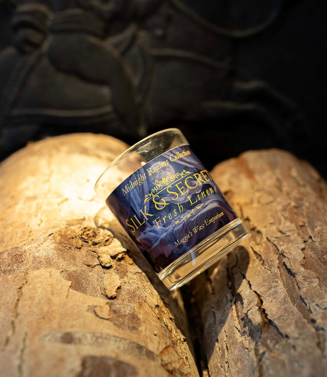 Candle with a blue label on a textured surface